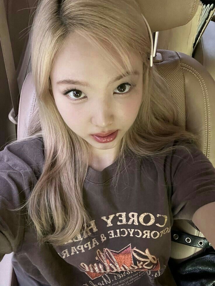 a young woman sitting in the back seat of a car