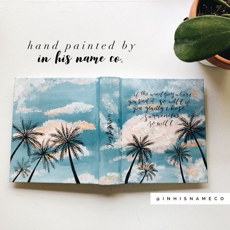 an open notebook with palm trees and the words hand painted by in his name