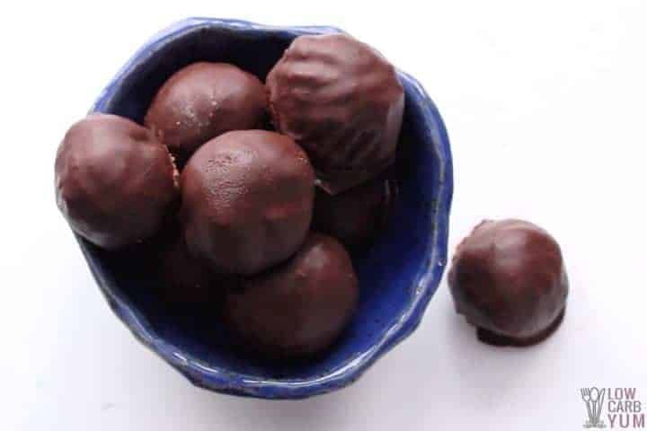 a blue bowl filled with chocolate candies on top of a white table