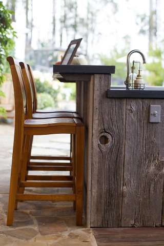 a wooden table with two chairs next to it and a laptop on top of the counter