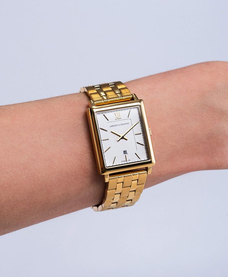 Combining the classic style of old vintage watches with an ultra-modern appeal, the large square-shaped 40mm dial features minimalist numerals and a subtle date display. Coming in four radiant colourways, Mixed Gold, Gold, Mixed Rose Gold, and Silver, Boyfriend pairs classic shades with timeless links made of sustainable stainless steel. Square Metal Dial Watches For Everyday, Square Metal Dial Watch For Everyday, Square Watch With Metal Dial For Everyday, Classic Gold Watch With Square Face, Minimalist Square Face Quartz Watch, Minimalist Square-faced Quartz Watch, Classic Square Analog Watches, Classic Square Analog Watch, Classic Square Face Watch With Metal Dial