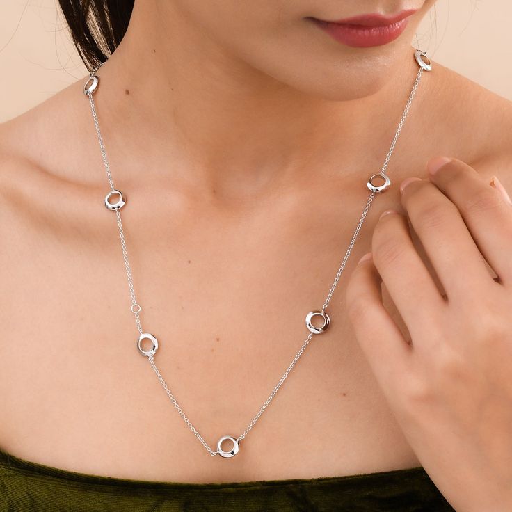 Complete your look with this classic station necklace. Circular stations at equidistance are studded with baguette-cut white zircons, with another side of plated silver. Adjustable in sizes 18, 24, and 30 inches, it can be worn in multiple ways by layering necklaces in various styles. Made in sterling silver Secured with lobster clasp Adjustable length - 18, 24, and 30 inches Diamond Cut Chain Necklace For Anniversary, Anniversary Diamond Cut Chain Necklace, Polished Fine Jewelry Chain Necklace, Elegant Silver Station Necklace With Diamond Accents, Polished Finish Fine Jewelry Chain Necklace, Formal Polished Chain Necklace, Silver Chain Necklace For Everyday Luxury, Classic Silver Station Necklace With Delicate Chain, Silver Station Necklace With Diamond Cut For Formal Events