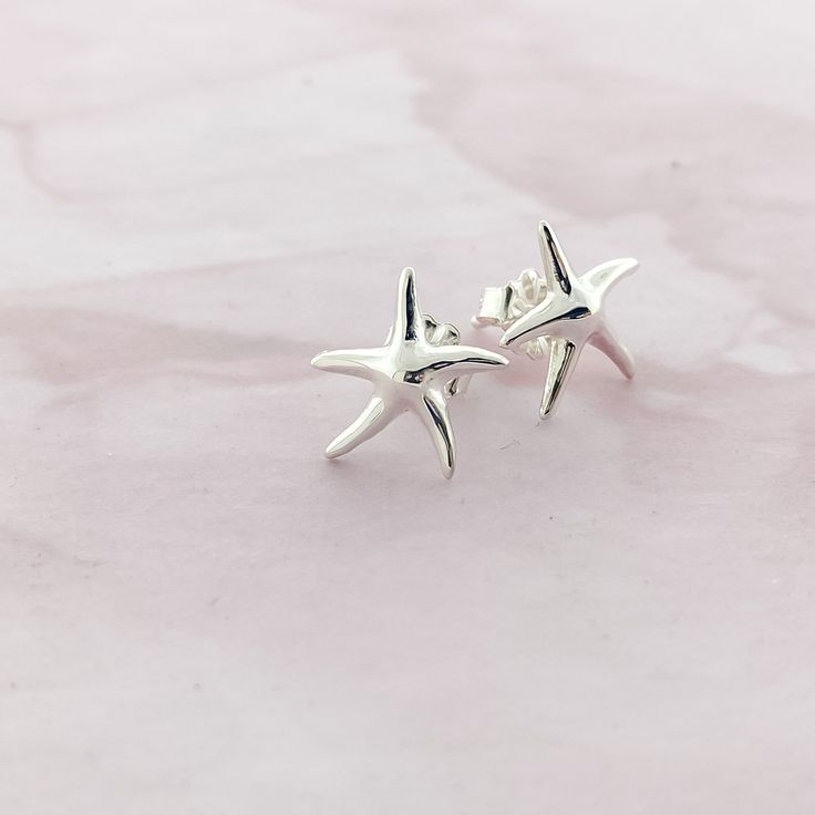 Dive into Ocean-Inspired Glamour with our Sterling Silver Dainty Starfish Stud Earrings Bring the enchanting allure of the sea to your jewelry collection with our exquisite Dainty Starfish Stud Earrings. These captivating earrings are meticulously crafted from 925 sterling silver, ensuring both enduring quality and a radiant shine that catches the light from every angle. Key Features: Charming Starfish Design: Each earring features a delicate and intricately detailed starfish, capturing the beau Starfish Design, Casual Beach Wear, Starfish Earrings, Tropical Escape, Ocean Inspired, Beach Lovers, Ocean Inspiration, 925 Sterling Silver Earrings, Exquisite Design