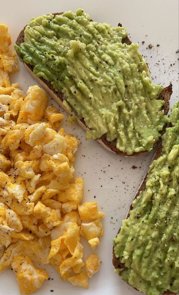 an avocado toast and scrambled eggs on a plate