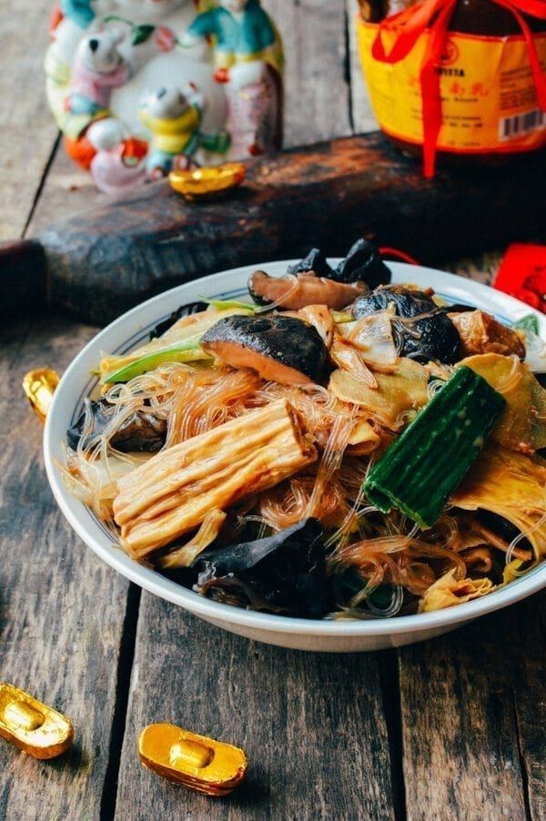 a white bowl filled with food on top of a wooden table