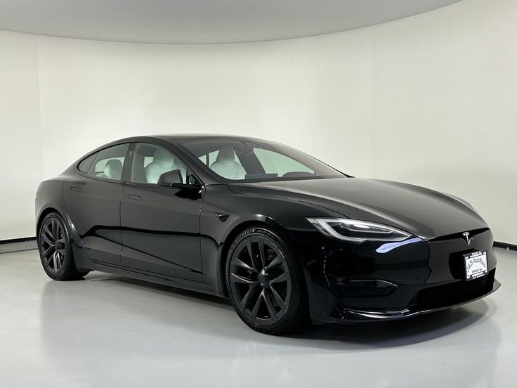 a black tesla car in a white room