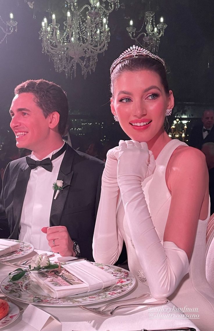 a man and woman sitting at a dinner table