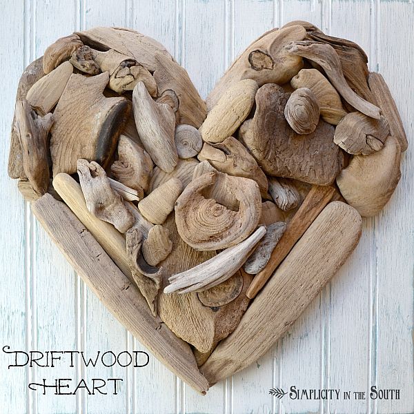 a heart made out of mushrooms on top of a wooden board with the words driftwood heart