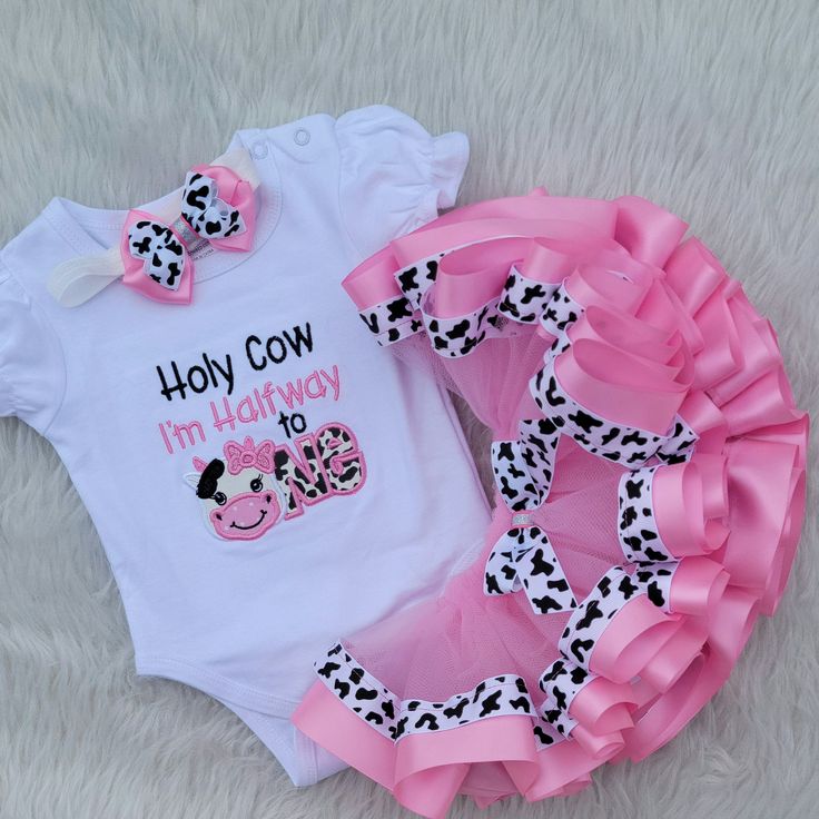 Girls Birthday Cow Outfit, Holy Cow Farm Birthday Outfit/Barnyard Birthday Shirt, Halfway to One Cow Outfit, 1st Birthday Cow Shirt This a beautiful Cow Themed Tutu Set.  If there are any small details you would like added or removed, please contact me prior to ordering. Comes with bodysuit or shirt and ribbon trimmed tutu.  If you are interested on the jacket also, please message me for a custom listing.  The headband (up to 12/18 months) or hair clip is free with the purchase and may vary in d Fitted Short Sleeve Sets For Birthday, White Cotton Birthday Set, Fun Cotton Sets For Birthday, Cute Short Sleeve Sets For Birthday, White Sets With Letter Print For Birthday, Customizable White Sets For Birthday, Fun White Sets For Birthday, Fun White Birthday Sets, Fun White Birthday Set