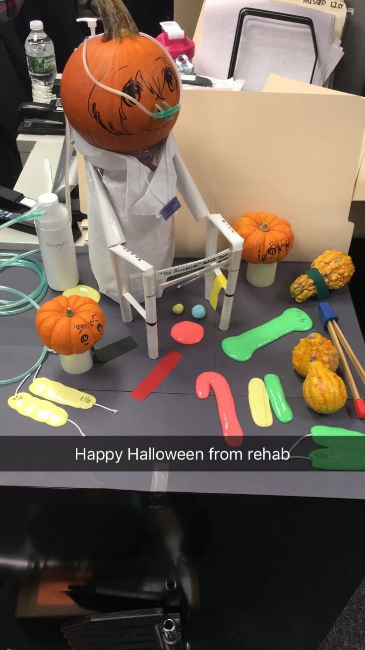 a table topped with fake pumpkins and other items on top of it's surface