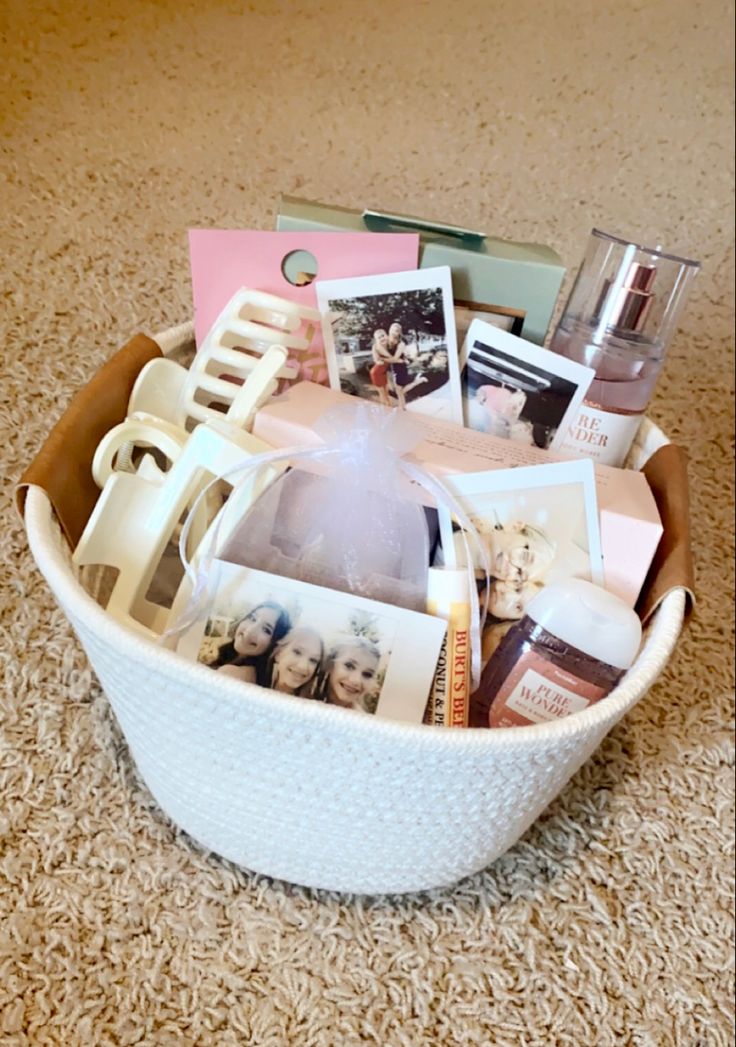 a white basket filled with pictures and other items on top of a carpeted floor