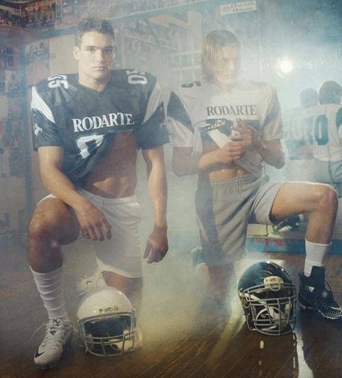 two football players are posing for a photo