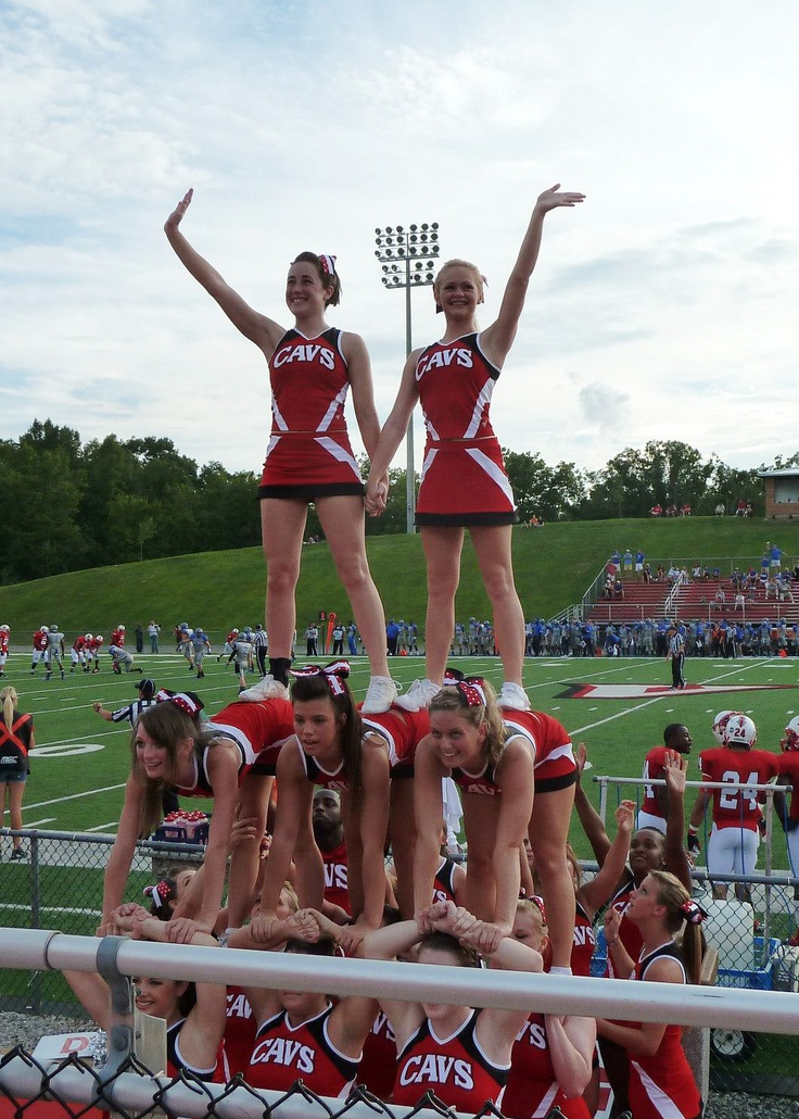 the cheerleaders are posing for a photo on the bleachers at a football game