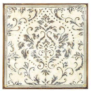 a white and brown wall hanging with an ornate design