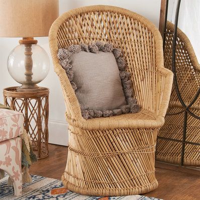 a wicker chair sitting next to a lamp