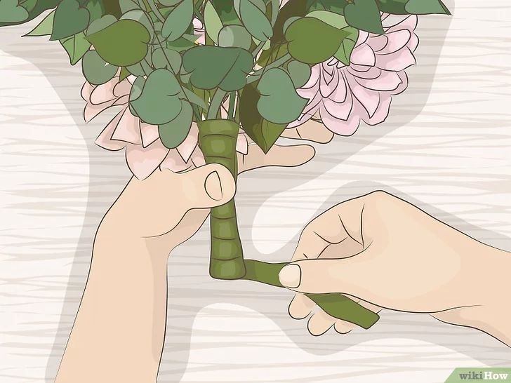 someone holding a bouquet with pink flowers in their hands and another hand reaching for it