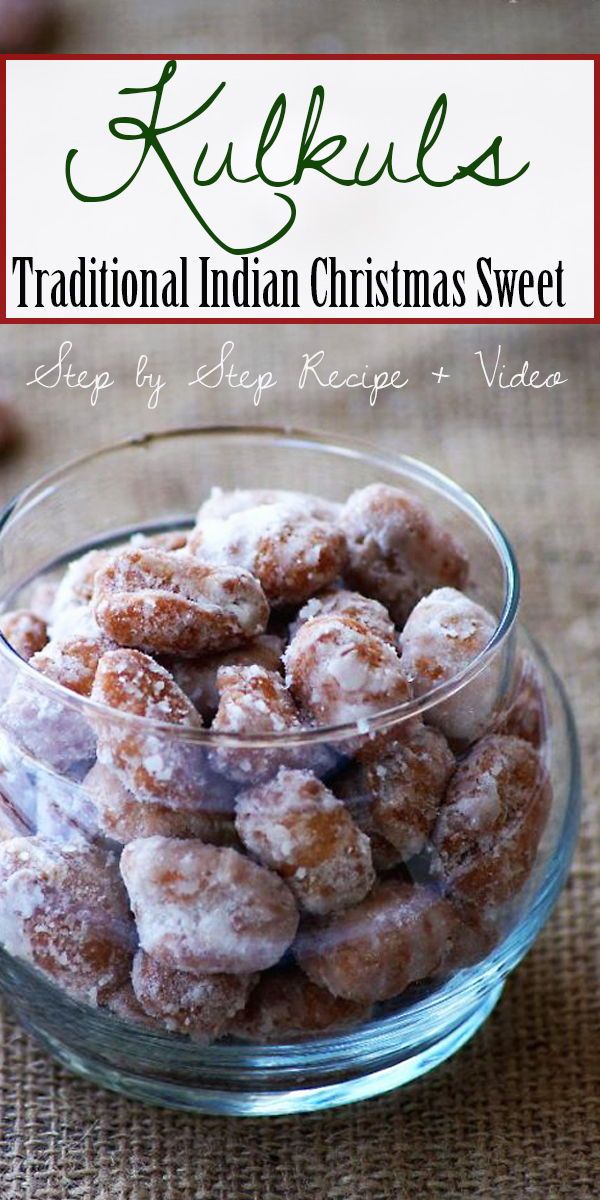 a glass bowl filled with powdered sugar covered doughnuts