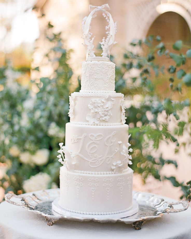 a white wedding cake sitting on top of a table