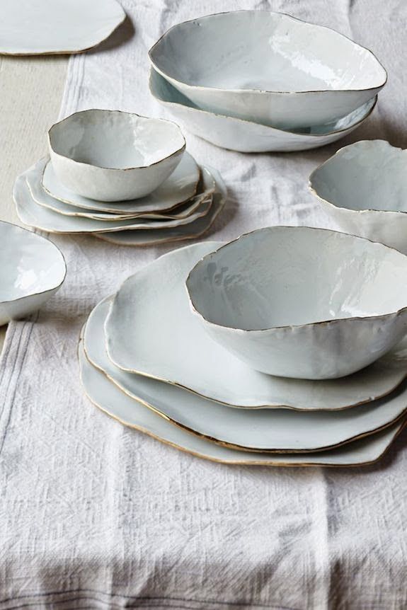 a table topped with lots of white plates