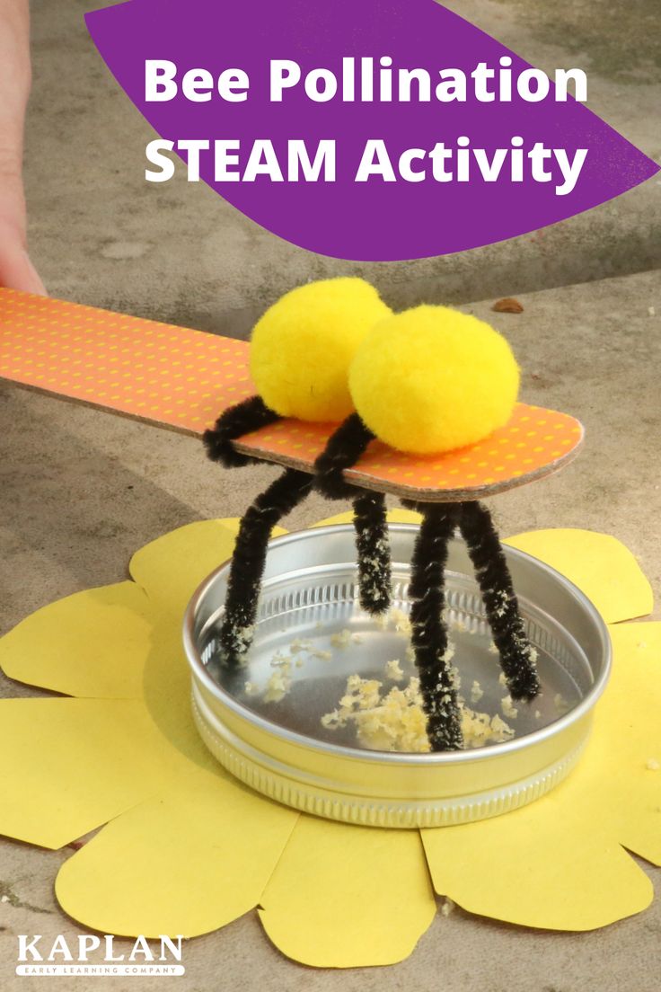 a person is holding two small yellow balls on top of a metal container with the words bee pollination steam activity