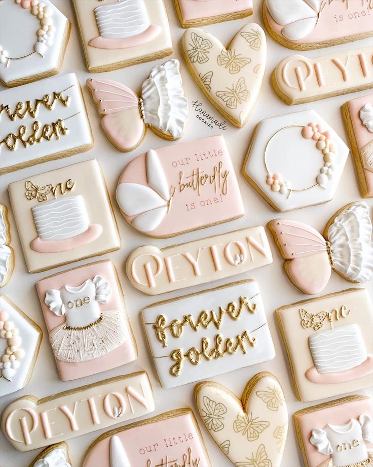 some cookies that are decorated with different designs and words on them, all in pastel colors