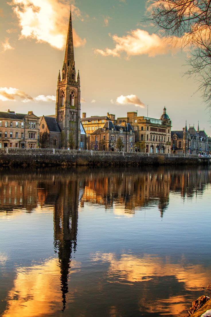 a large body of water with buildings in the background