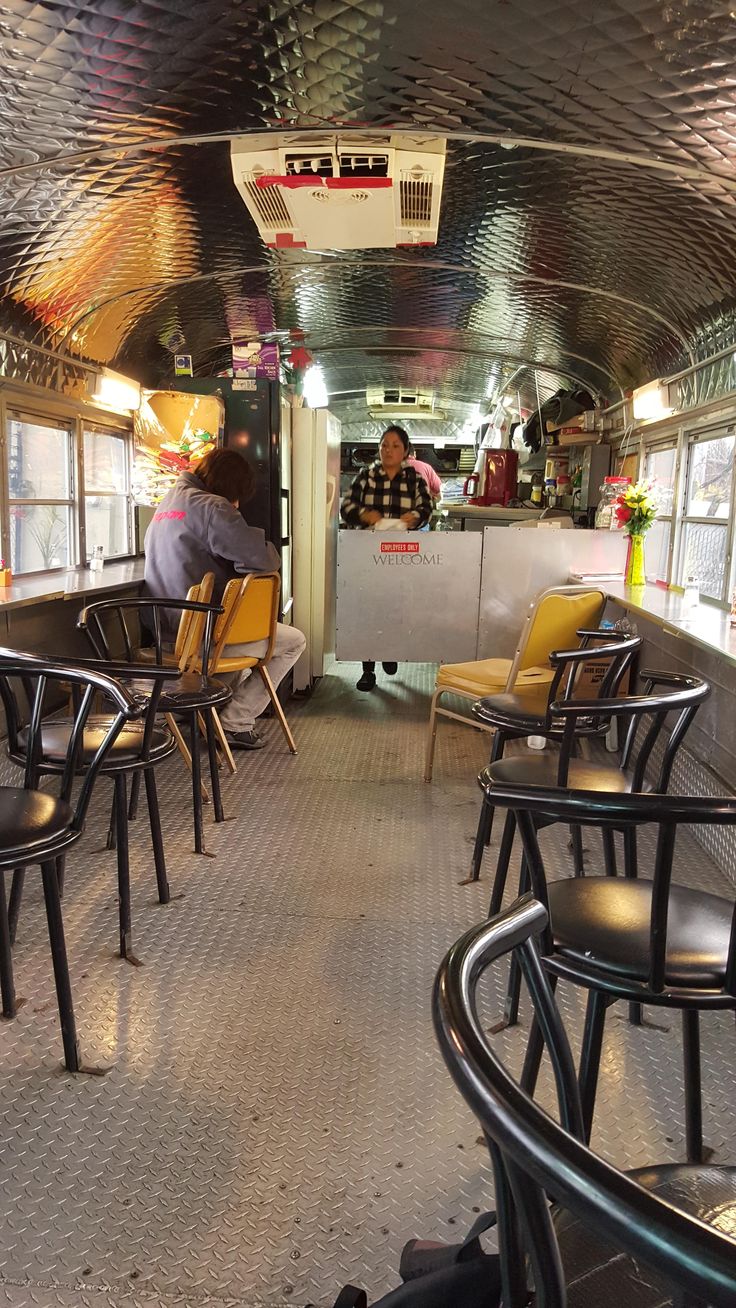 the inside of a restaurant with tables and chairs