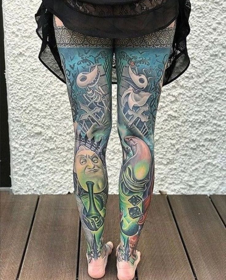 a woman with tattoos on her legs and leggings