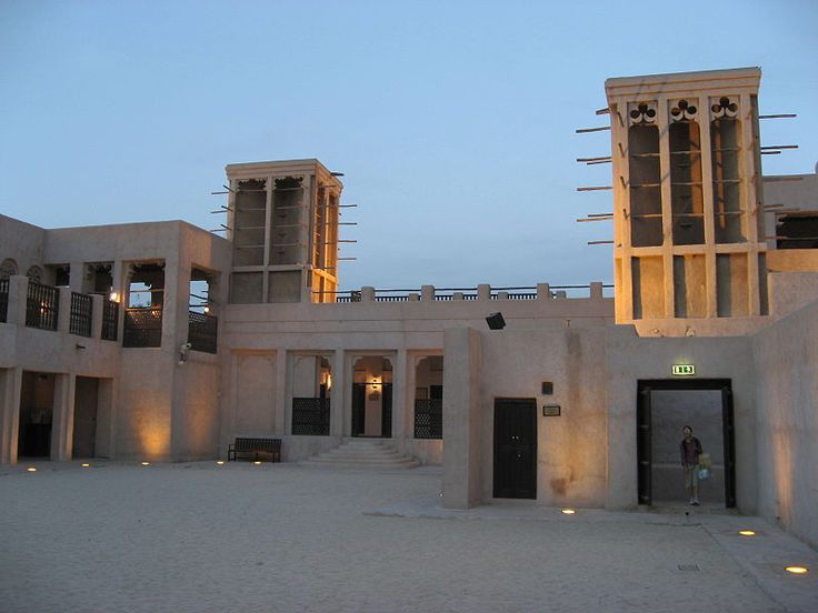 an empty courtyard with two tall buildings in the background