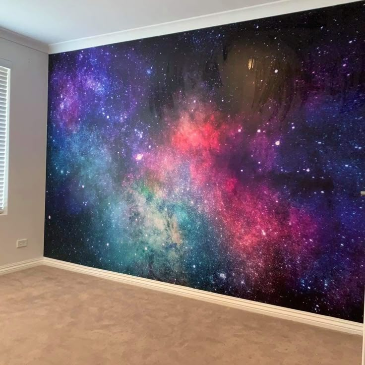 an empty room with a large wall mural in the center and colorful stars on it