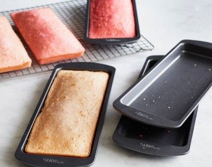 three different types of cakes on trays next to each other, with one being baked