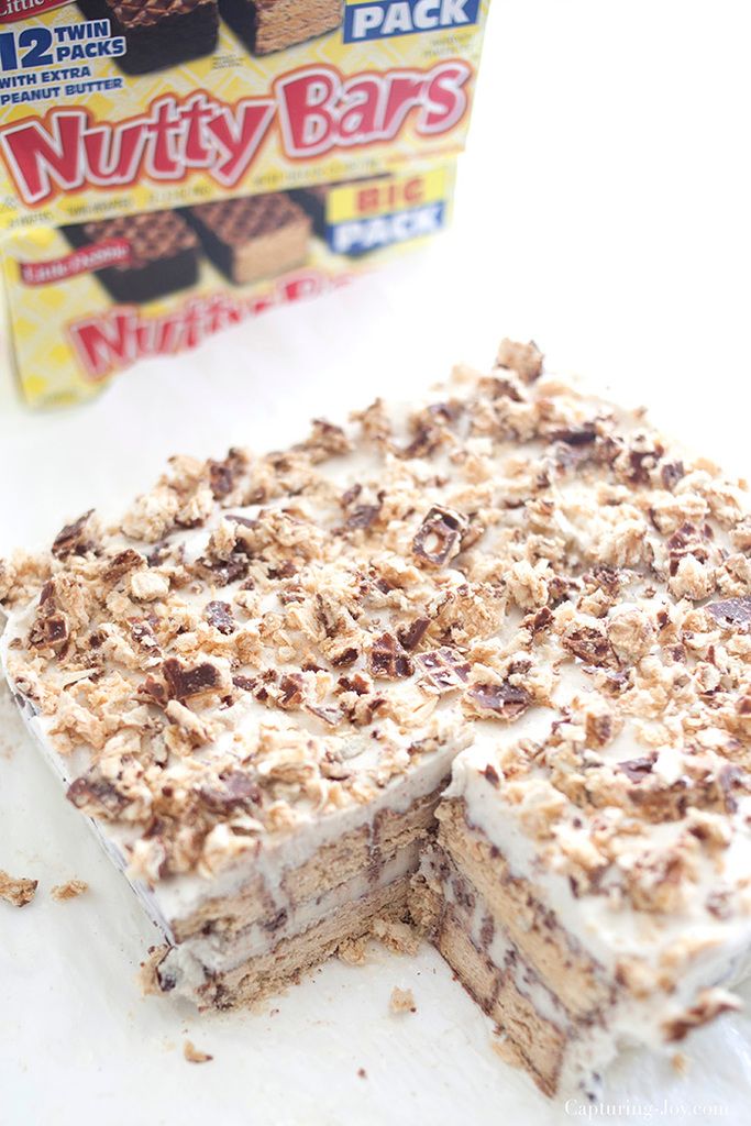 a box of nutty bars next to a piece of cake