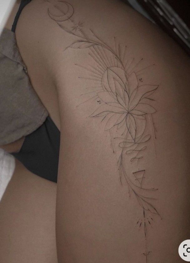 the back of a woman's stomach with an intricate tattoo design on her left side