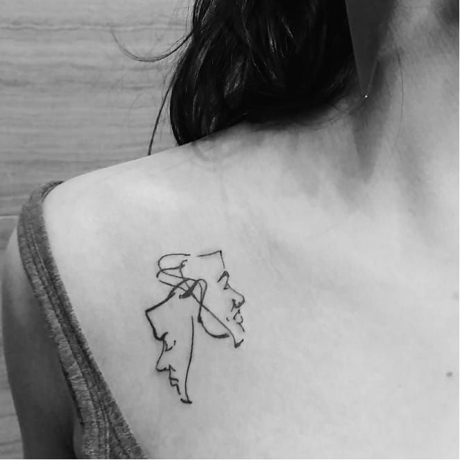 a woman with a tattoo on her shoulder