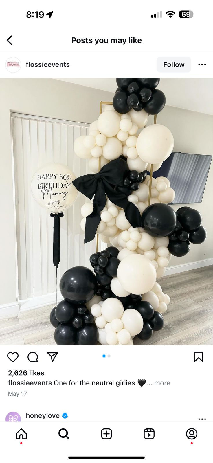 a bunch of black and white balloons in the shape of a tower on top of each other