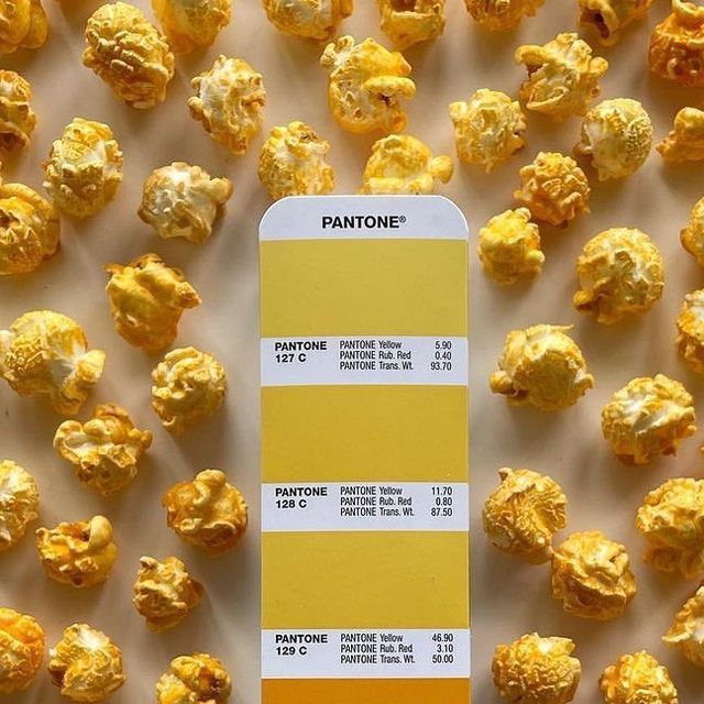 a pantone color swatch with popcorn scattered around it