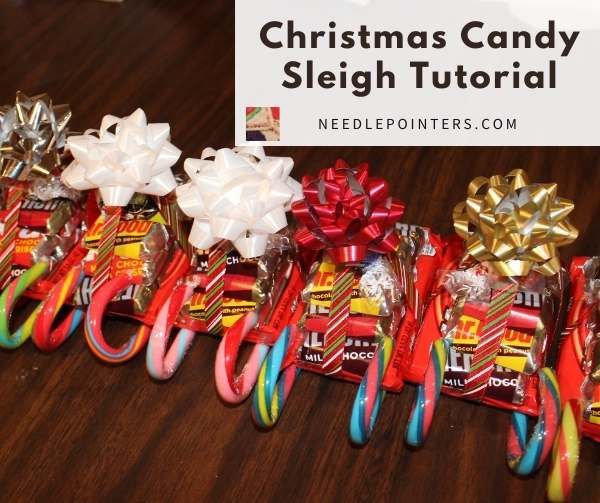 christmas candy sleighs are lined up on a table with ribbons and bows