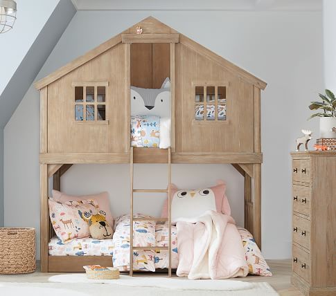 a child's bedroom with a wooden bunk bed and white rug on the floor