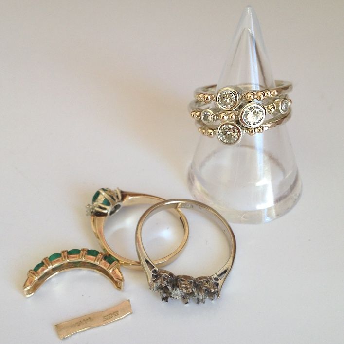 three rings and a ring holder on a table