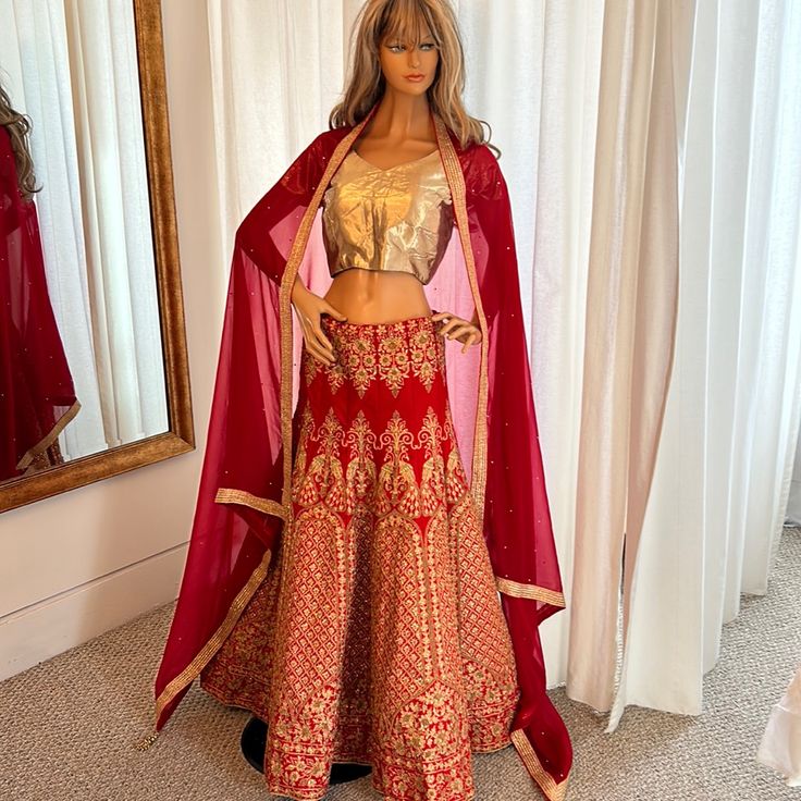 Very Bold In Red And Gold! This Gorgeous Lehenga Is Definitely Worth It’s Weight! Bust Currently Measures 36 Inches And Has Additional 2 Inches On Each Side For Let Out. Waist Measures 35 Inches And Has Adjustable Drawstring Waist. Length Of Skirt Is 41 Inches From Waist To Hem. One Of The Most Well-Made Pieces We’ve Seen. Red Sets With Sheer Dupatta For Navratri, Red Choli With Resham Embroidery, Elegant Red Gota Work Choli, Elegant Red Choli With Gota Work, Red Choli For Reception, Festive Red Set With Sheer Dupatta, Red Choli With Sheer Dupatta, Fitted Red Lehenga With Gota Work, Fitted Red Sharara With Gota Work