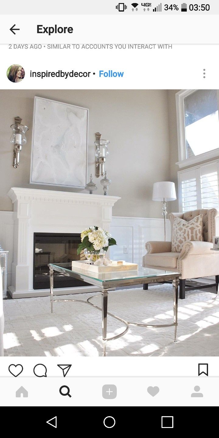 a living room filled with furniture and a fire place in front of a white fireplace