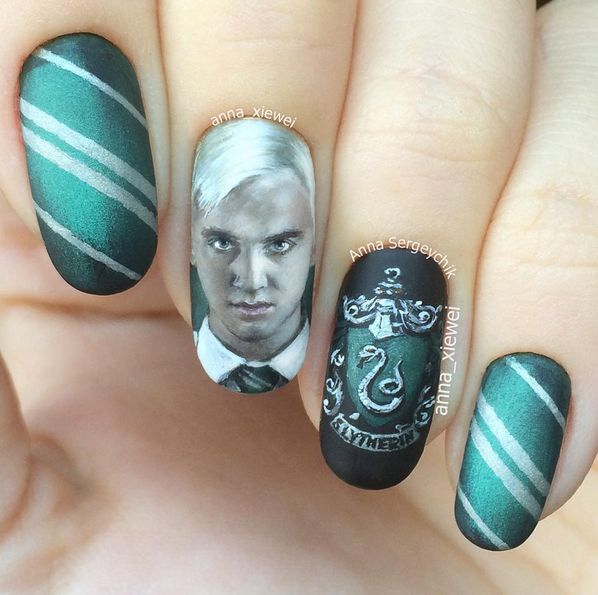 a woman with green and white nails has a harry potter manicure