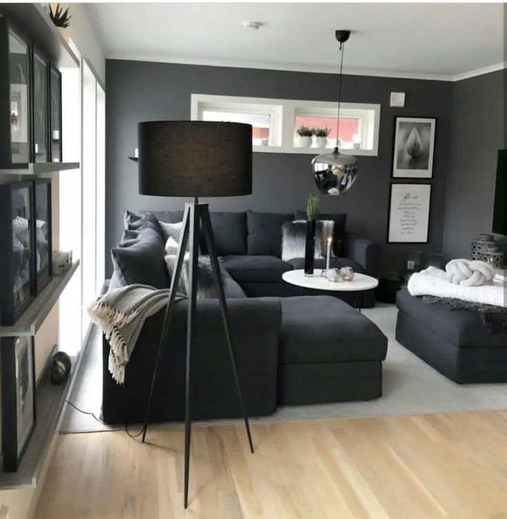 a living room filled with furniture and pictures on the wall