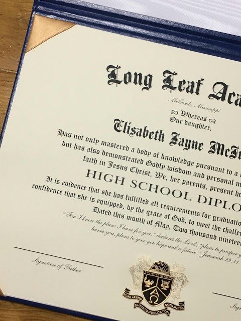 a diploma is laying on top of a wooden table