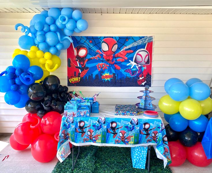 a spiderman birthday party with balloons and decorations