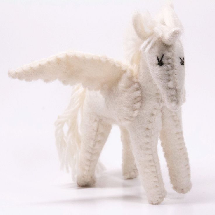 a white stuffed animal with wings on it's back and eyes closed, standing in front of a white background