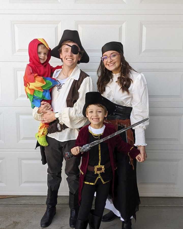 two adults and a child dressed up as pirates