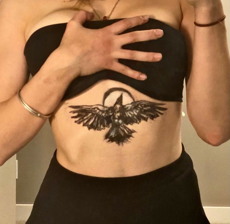 a woman with a tattoo on her stomach