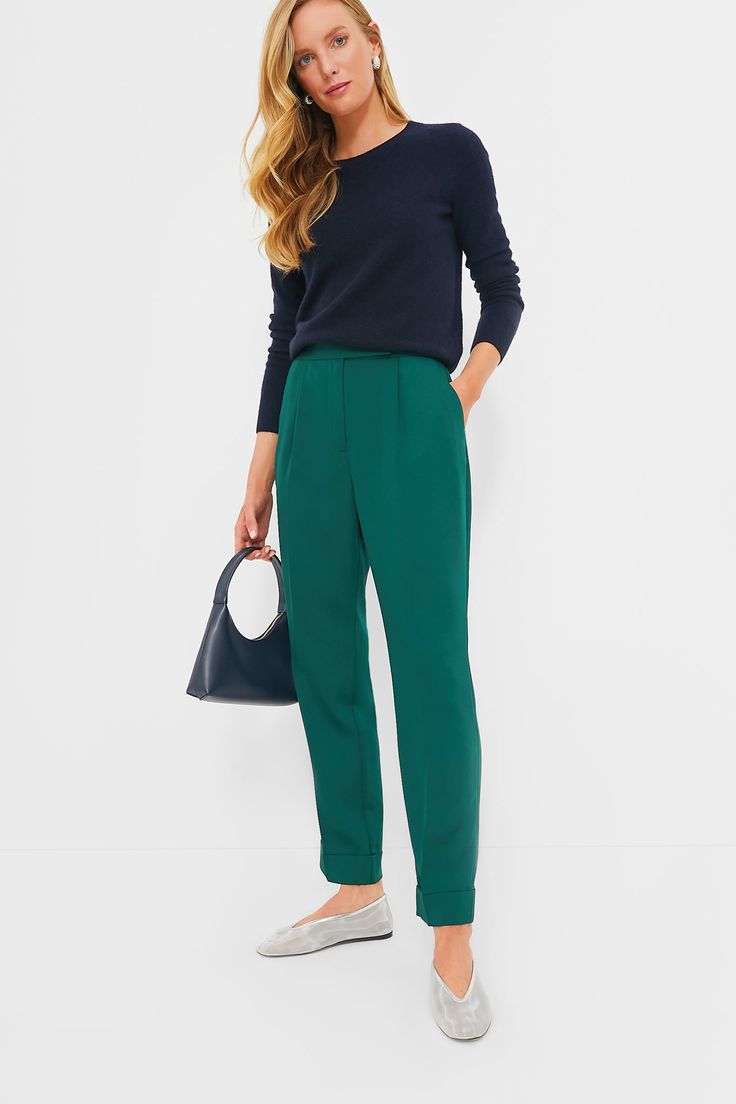 The ultimate closet staple in a fresh colorway, the Dark Green Duncan Pleated Trouser is the pair of pants that will complete your wardrobe and having you reaching for them on repeat. With a flattering high rise, elongating front pleats, and a chic straight leg silhouette, these are perfect from desk to drinks and everywhere in between. Pair them with a tailored blazer, a slouchy tee, or a cardigan — trust us, these can do it all! High rise Zip fly with hidden hook and eye closure Angled hip pockets Pleated front Straight leg Fixed cuff at hem Material: 100% Polyester Care: Machine wash cold, tumble dry low. Do not bleach, low iron if needed Element Of Surprise, Modern Bag, Two Friends, Plus And Minus, Mansur Gavriel, Work Wardrobe, Mesh Material, On Repeat, Pair Of Pants