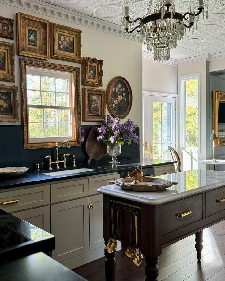 a large kitchen with an island and chandelier hanging from it's ceiling